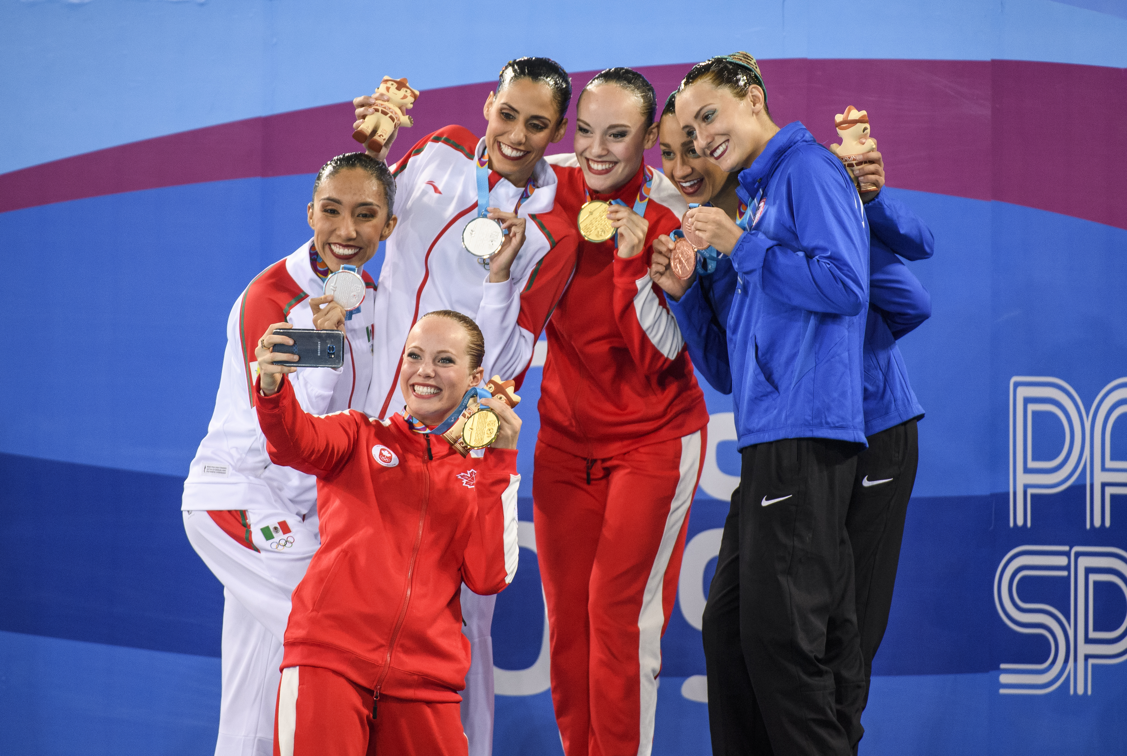 Claudia Holzner and Jacqueline Simoneau pose with other medalists