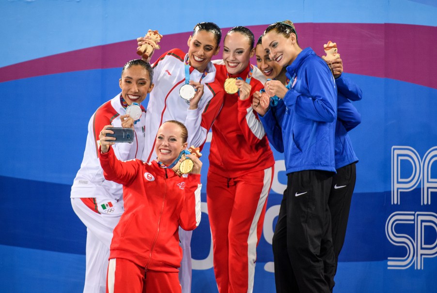 Claudia Holzner and Jacqueline Simoneau pose with other medalists