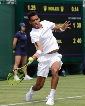 Felix Auger-Aliassime hitting ball