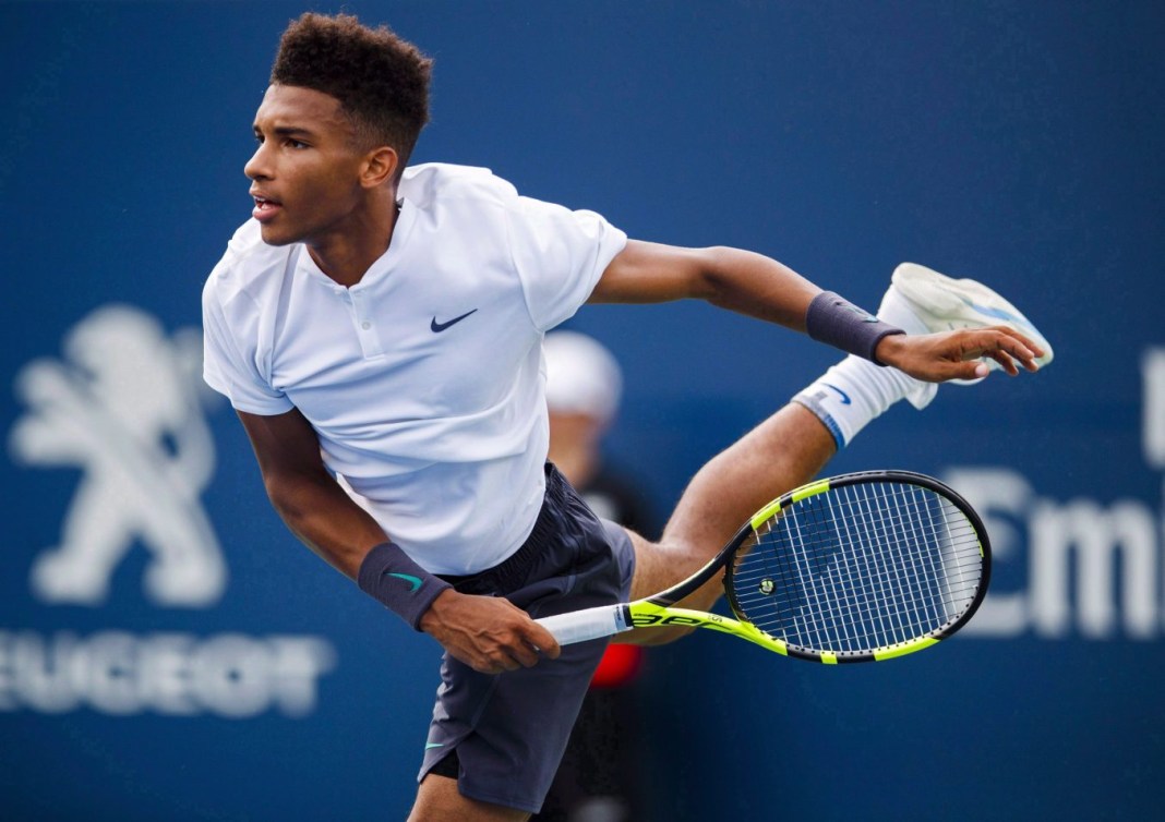 Felix Auger-Aliassime, of Canada, serves