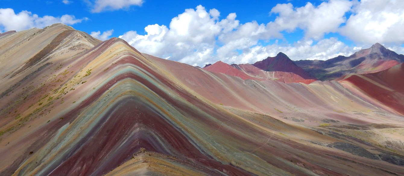 Blue skys and a scenic view of reds, greens and golds in the mountains