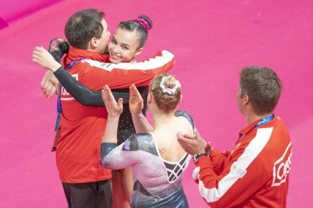 Brooklyn C. Moors celebrates with Ellie Black and coaches