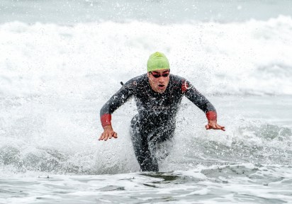 athlete jumps in the water