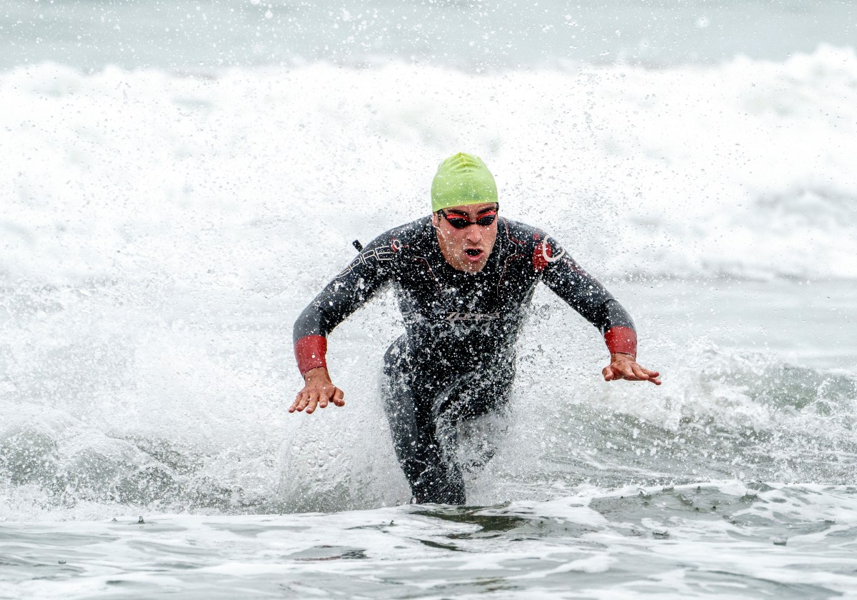 athlete jumps in the water