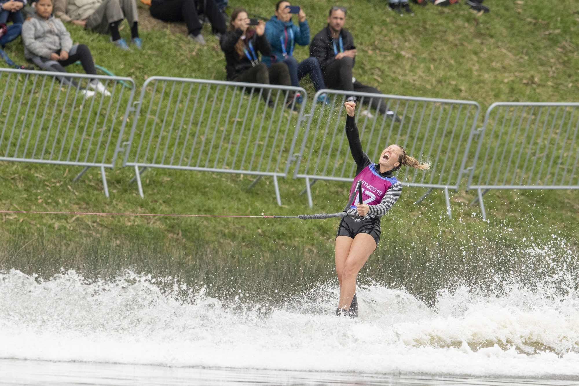 Waterskier pumps fist on water