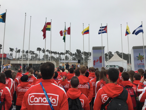 Athletes watching the flags raise