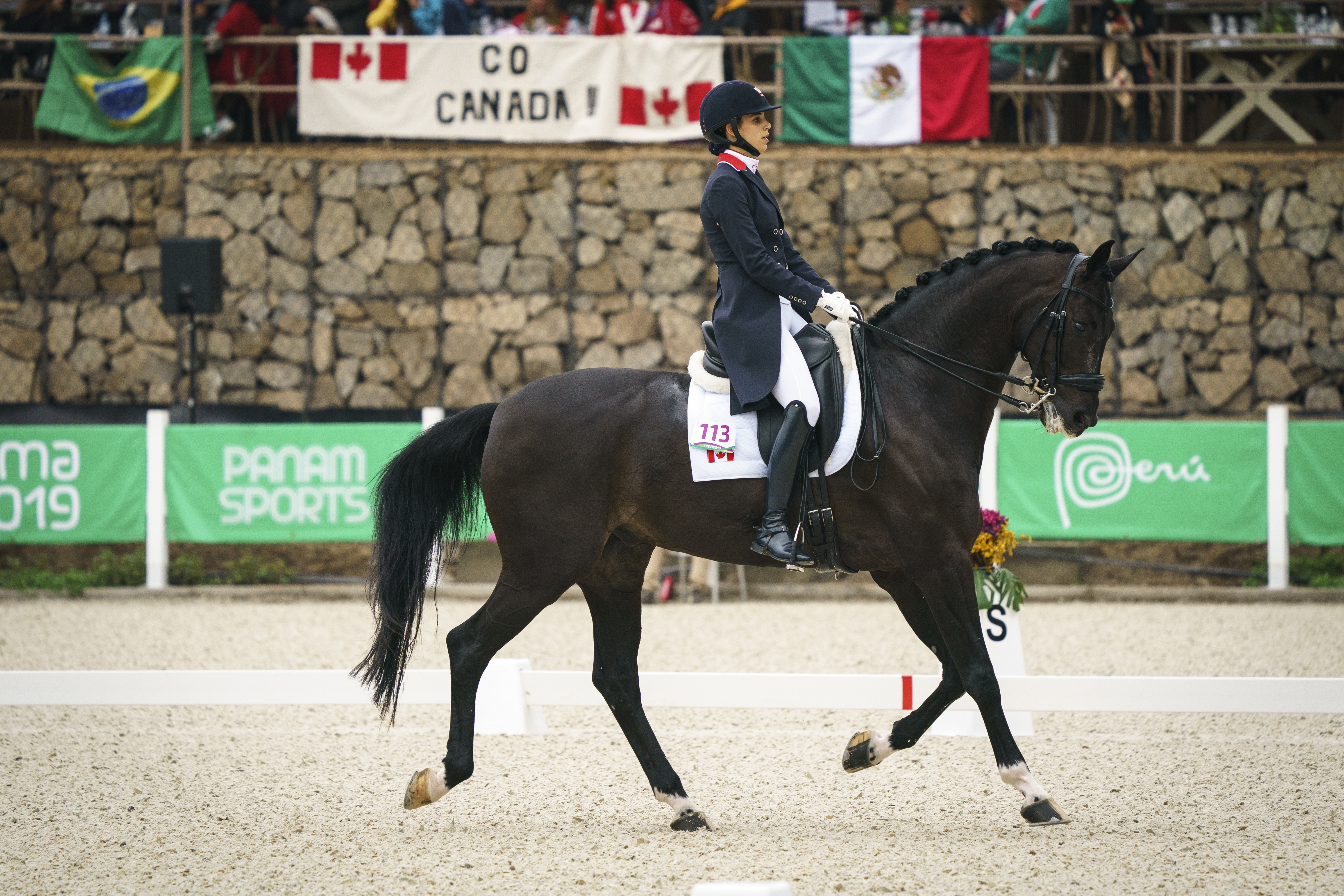 Anima Moreira rides past go Canada sign