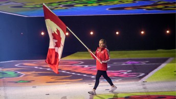 Canadian athlete carries flag