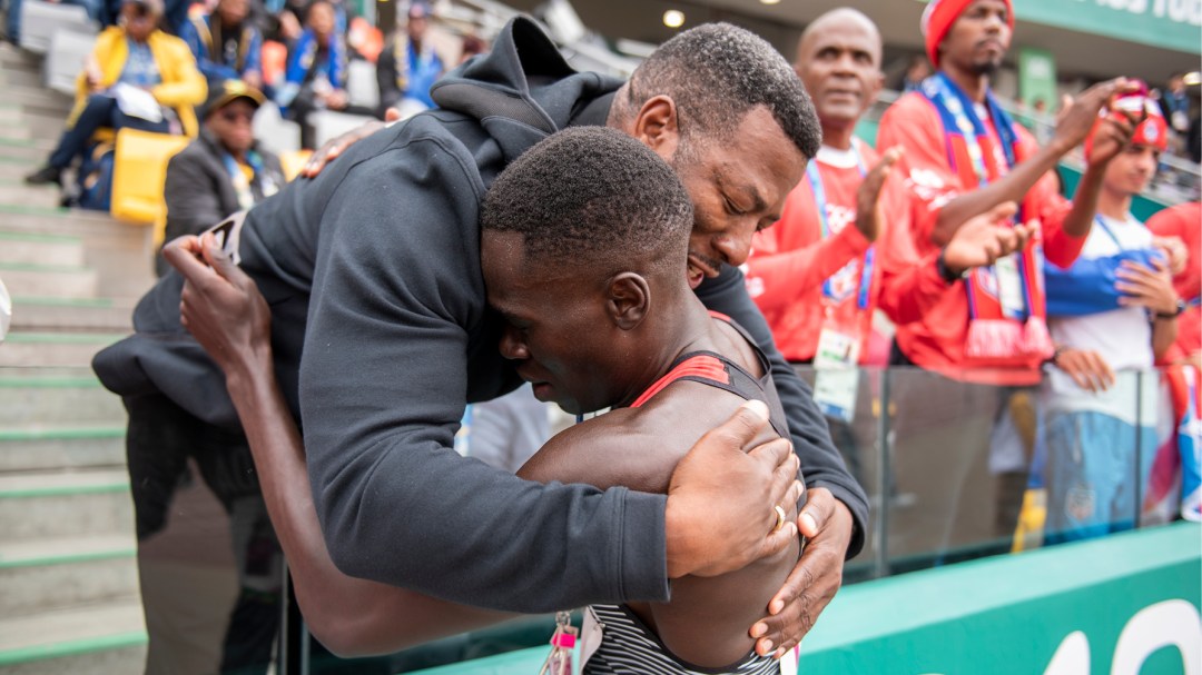 Athlete hugs coach