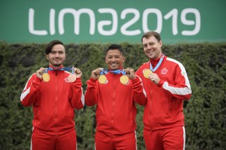 Three athletes pose with their medals.