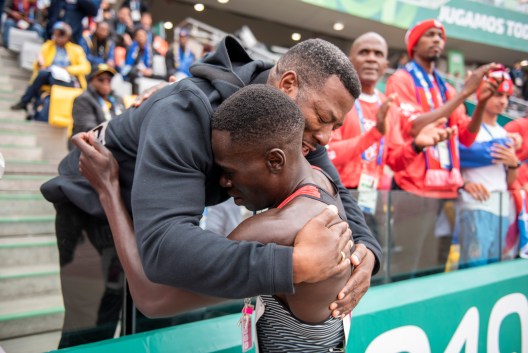 Marco Arop hugs his coach