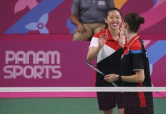 two badminton players high five