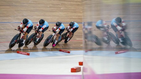 four cyclists on a track