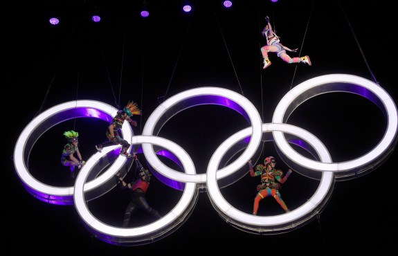 Actors perform alongside the Olympic rings which are up in the air
