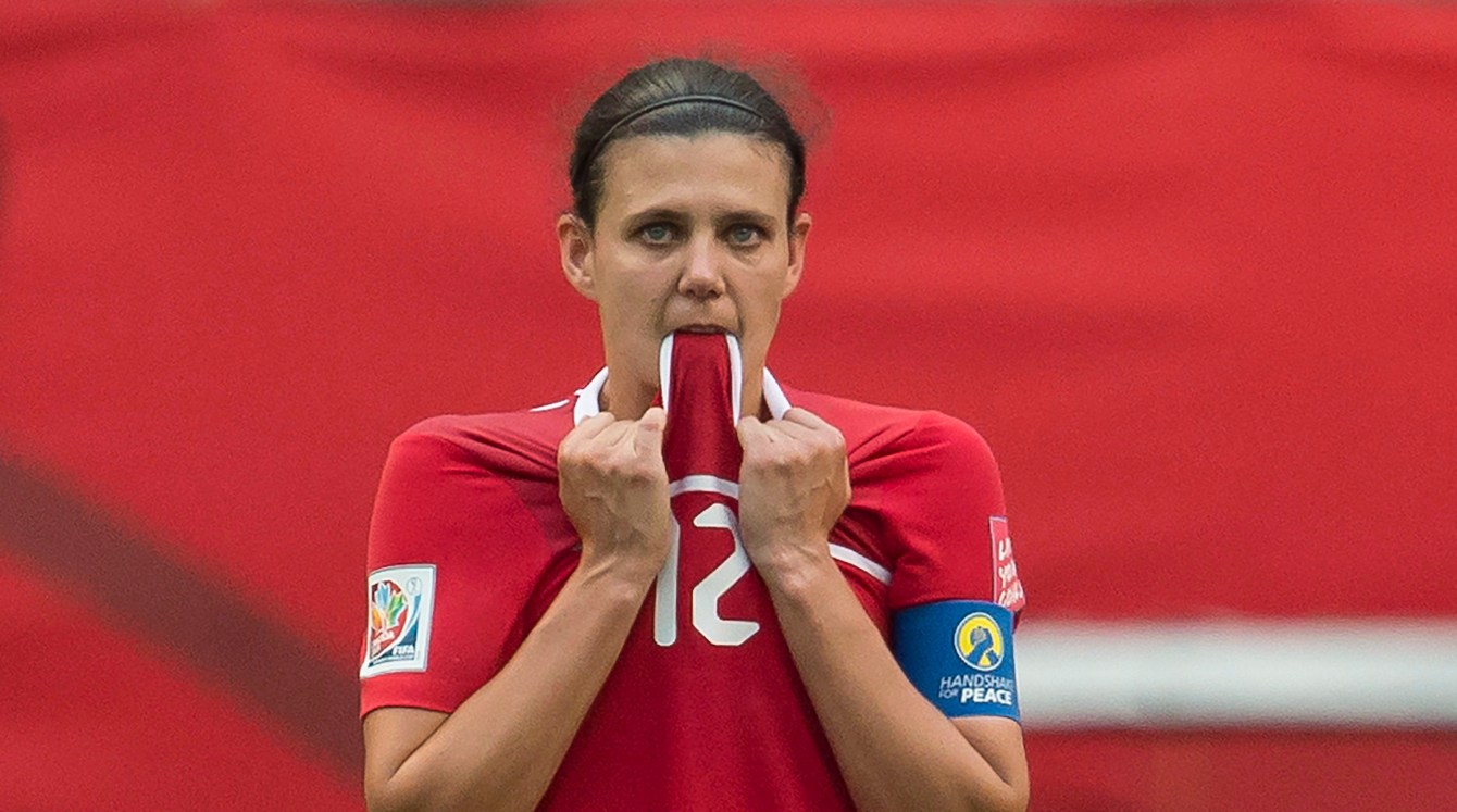 Christine Sinclair biting her jersey