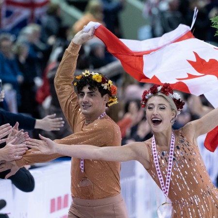 Piper Gilles Paul Poirier Piper Gilles and Paul Poirier reach out to the crowd during victory ceremonies at Skate Canada