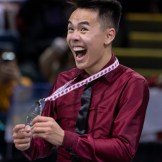Nam Nguyen smiles as he holds his silver medal