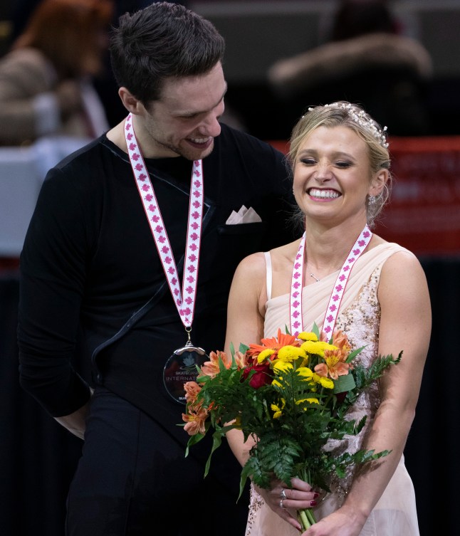 Kirsten Moore-Towers and Michael Marinaro share a laugh during victory ceremonies