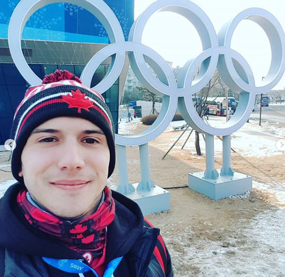 Adam poses in front of the rings inPyeongChang
