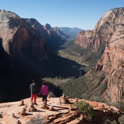 Two hikers overlook Zion's Canyon.