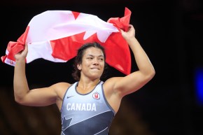 Justina holds the Canadian flag above her head.