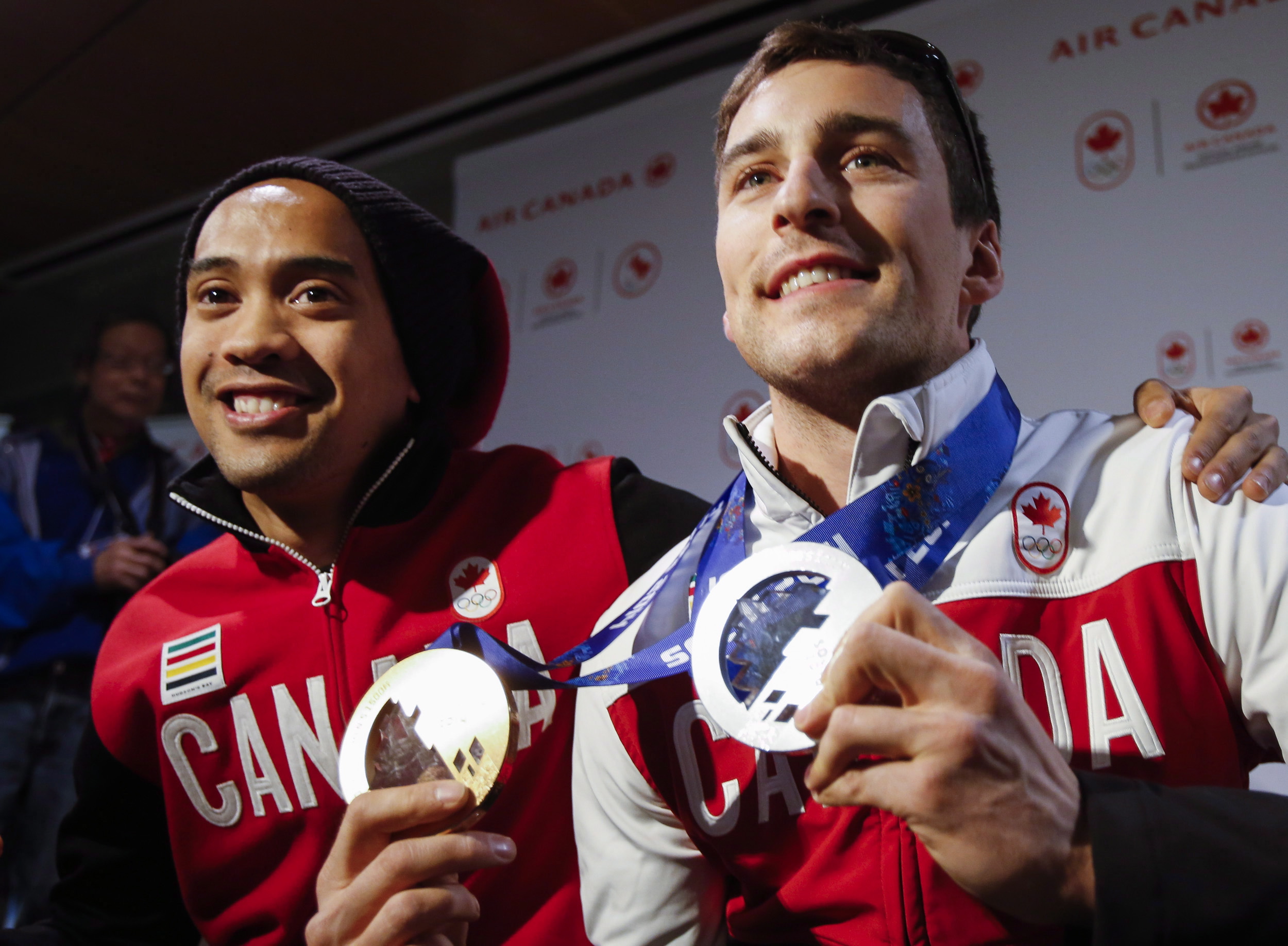 Denny Morrison, right, and Gilmore Junio arrive home from the Sochi Olympics in Calgary