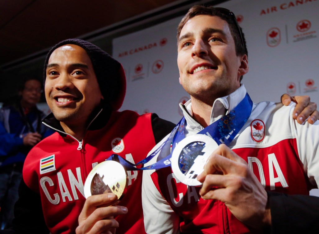Denny Morrison, right, and Gilmore Junio arrive home from the Sochi Olympics in Calgary