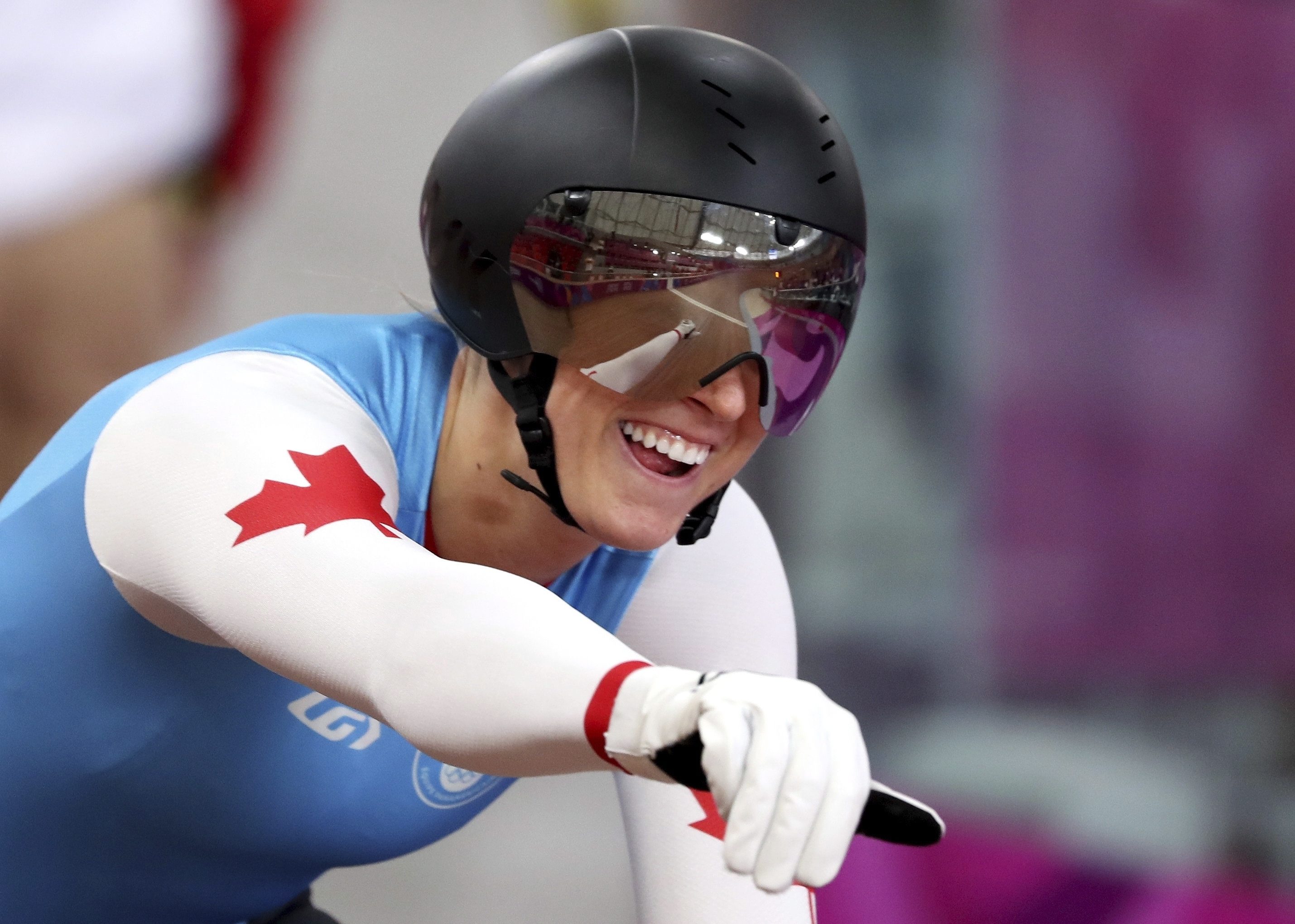 Kelsey Mitchell of Canada celebrates after qualifying for the track cycling women's sprint final.