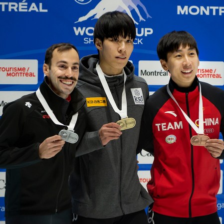 SPD Short Track 20191109 steven dubois on the podium posing with his silver medal alongside the gold and bronze medal