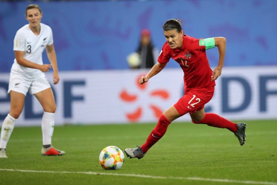 Christine Sinclair runs with ball