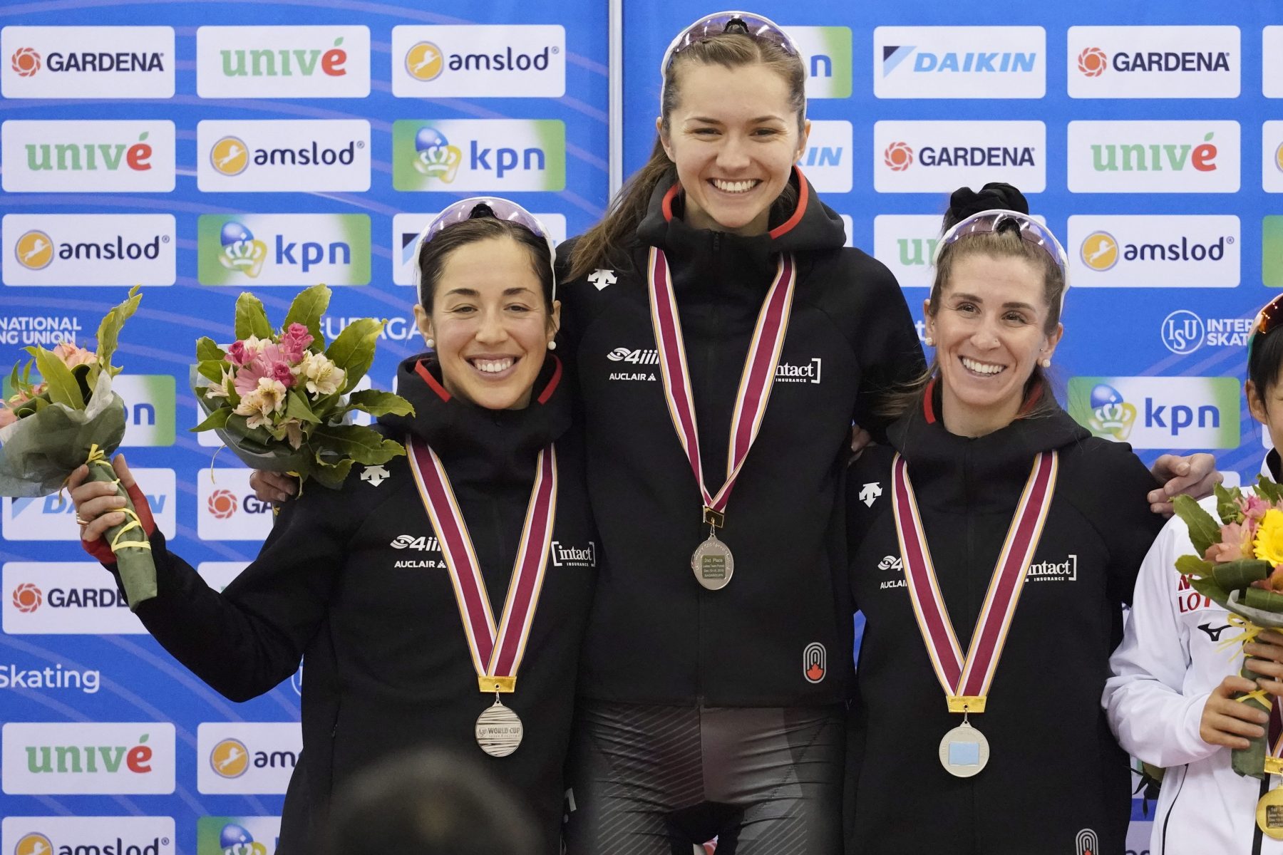 Second placed Canada team, Ivanie Blondin, Isabelle Weidemann and Valerie Maltais, celebrate on the podium during a medal ceremony for the ladies team pursuit race of the speed skating World Cup at the M-Wave in Nagano, Japan, Sunday, Dec. 15, 2019. (AP Photo/Toru Hanai)