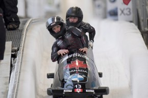 Driver Christine de Bruin, and brakeman Kristen Bujnowski of Canada, finish third place in the women's bobsled World Cup race, in Lake Placid, N.Y., on Saturday, Dec. 14, 2019. (AP Photo/Hans Pennink)