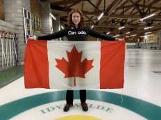 Lauren holds the Canadian flag.