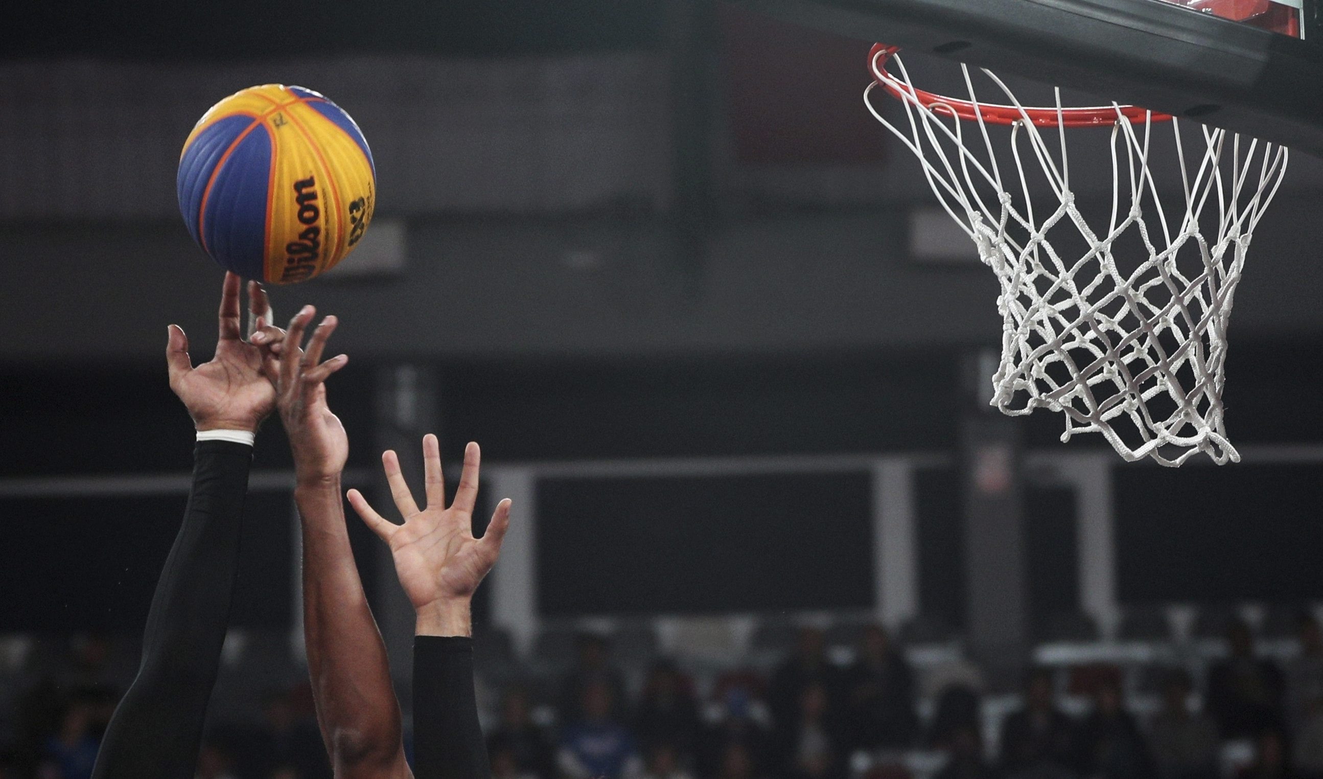 Teammates double up to block a shot during the men's basketball 3x3 semi-final match at the Pan American Games in Lima, Peru,