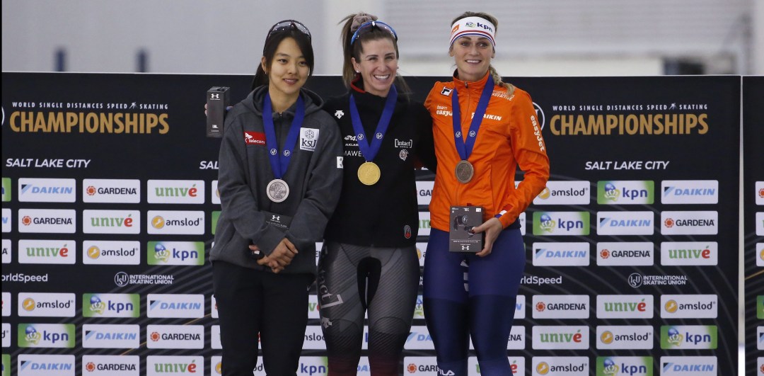 Speed skating medallists stand on podium after competing in women's mass start