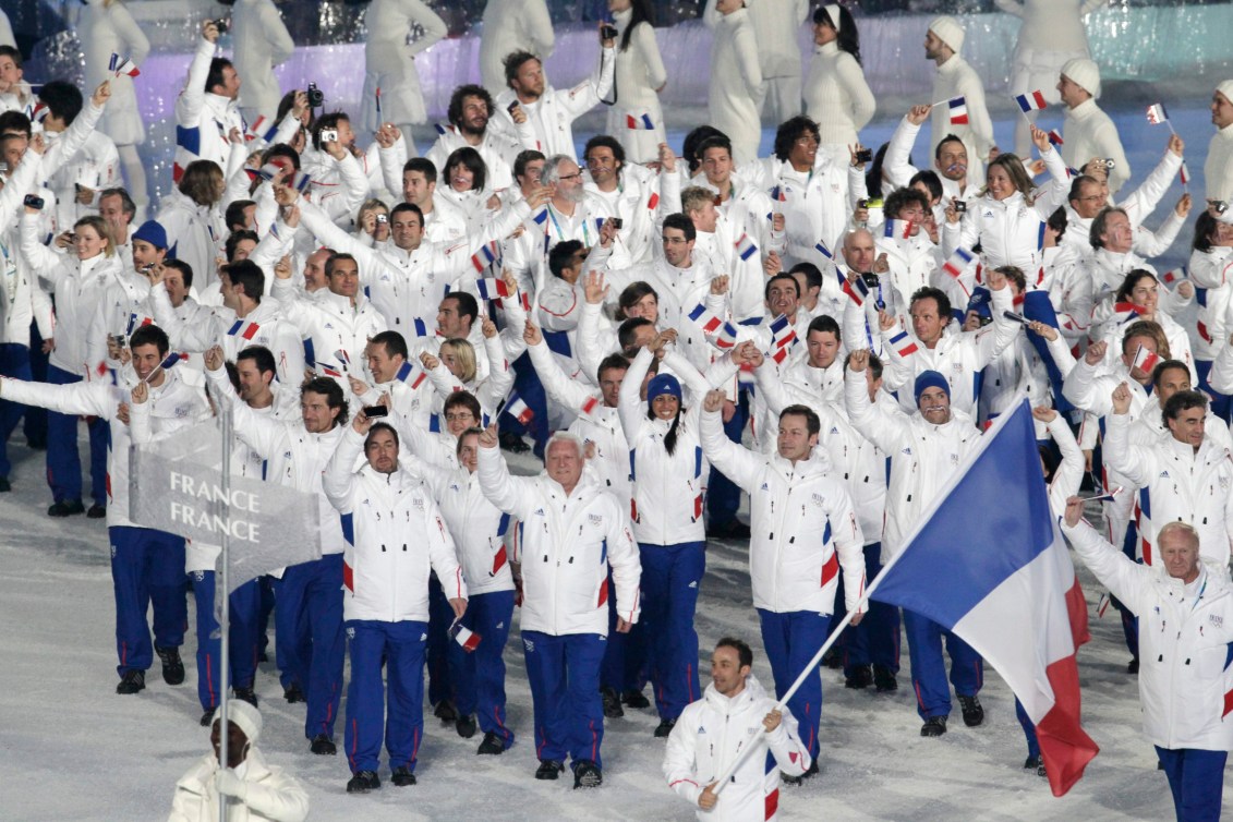 France's Vincent Defrasne carries the flag during the opening ceremony for the Vancouver 2010 Olympics in Vancouver, British Columbia, Friday, Feb. 12, 2010.