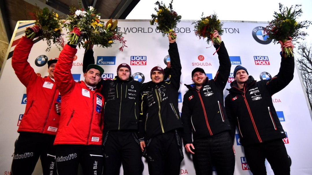 Bobsled medallists stand on the podium at the World Cup in Latvia
