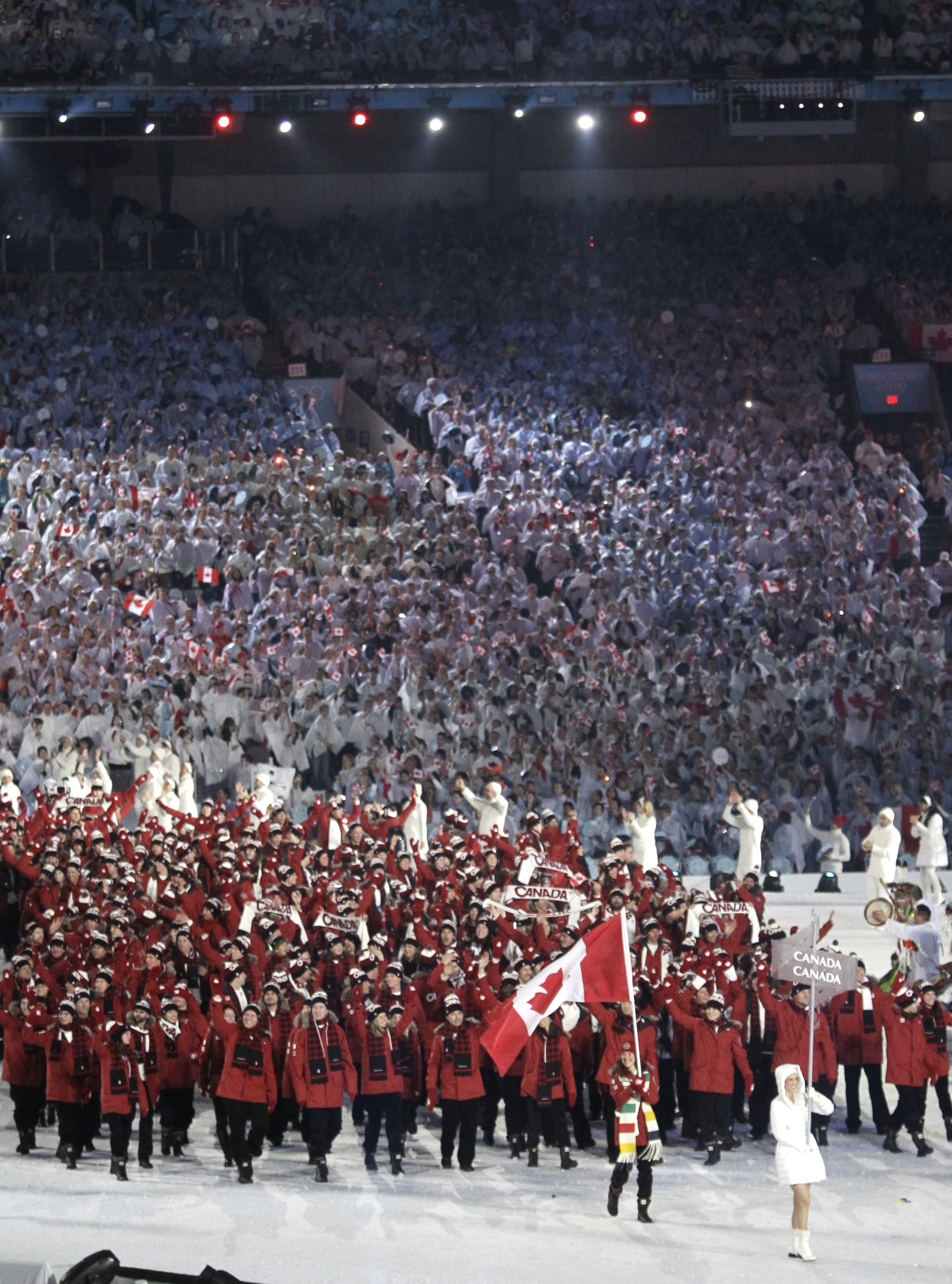 Canada's Clara Hughes carries the flag during the opening ceremony for the Vancouver 2010 Olympics in Vancouver, British Columbia, Friday, Feb. 12, 2010.