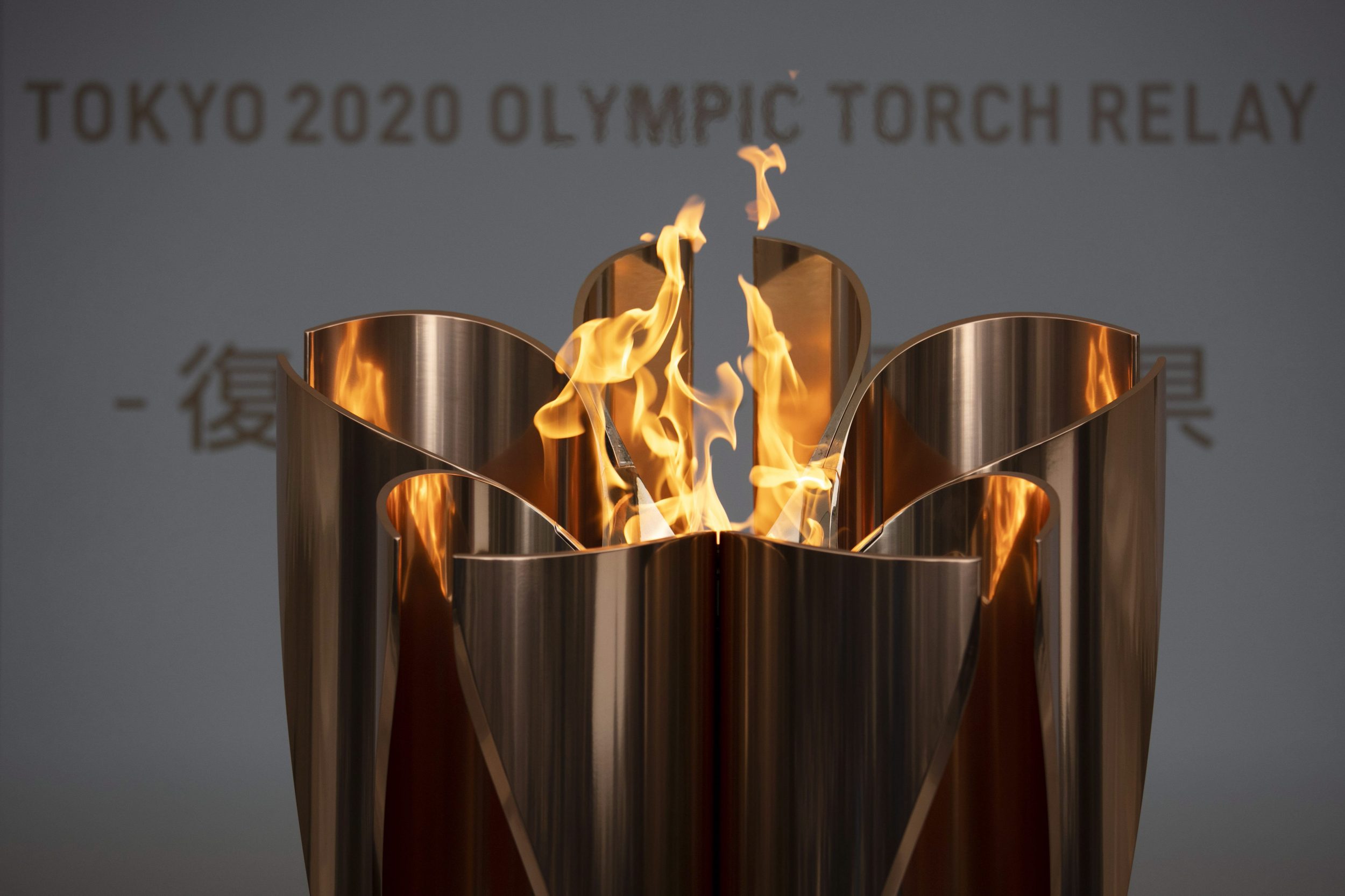 The Tokyo 2020 Olympic flame burns during the postponement of the Games