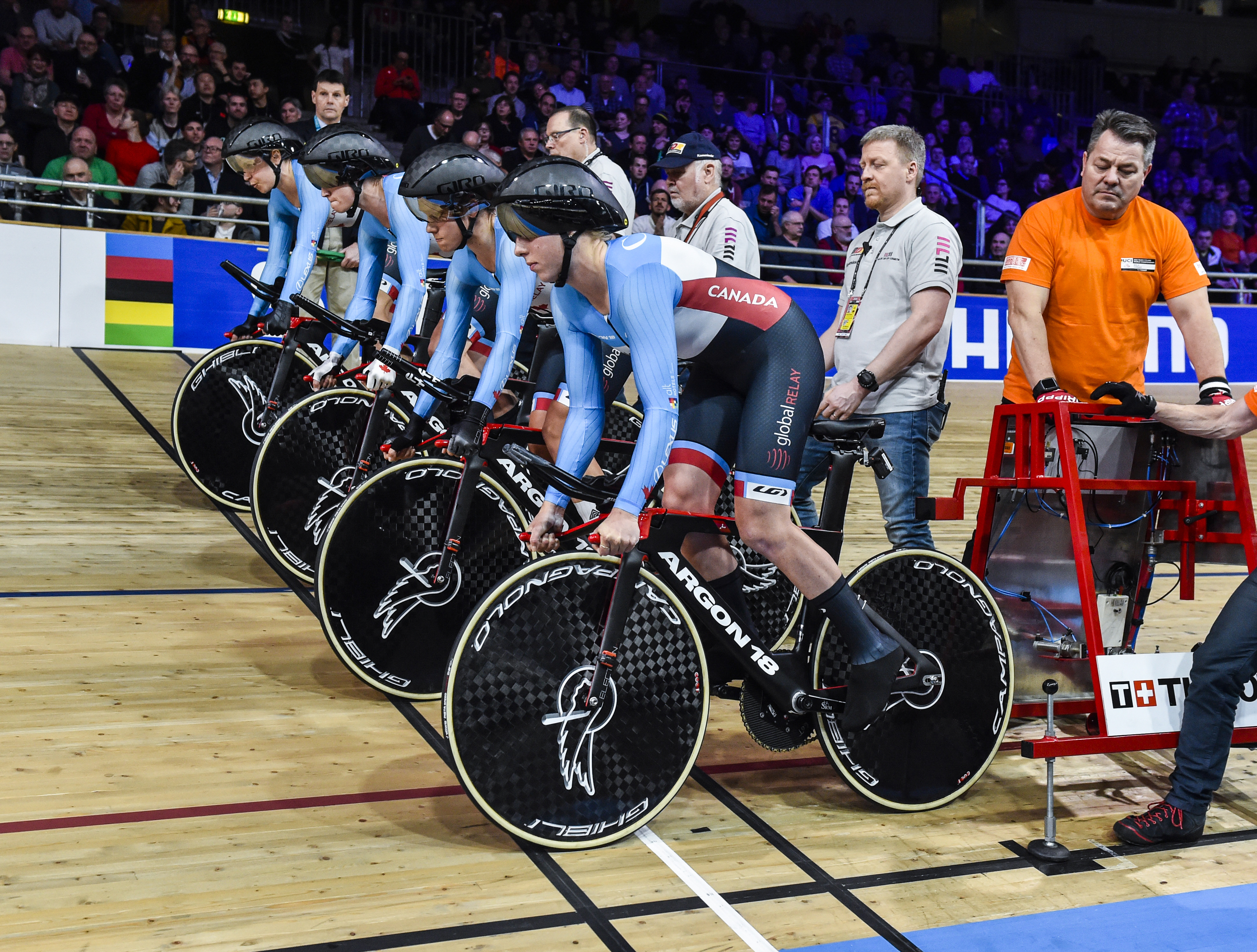 Four cyclists lined up at starting line