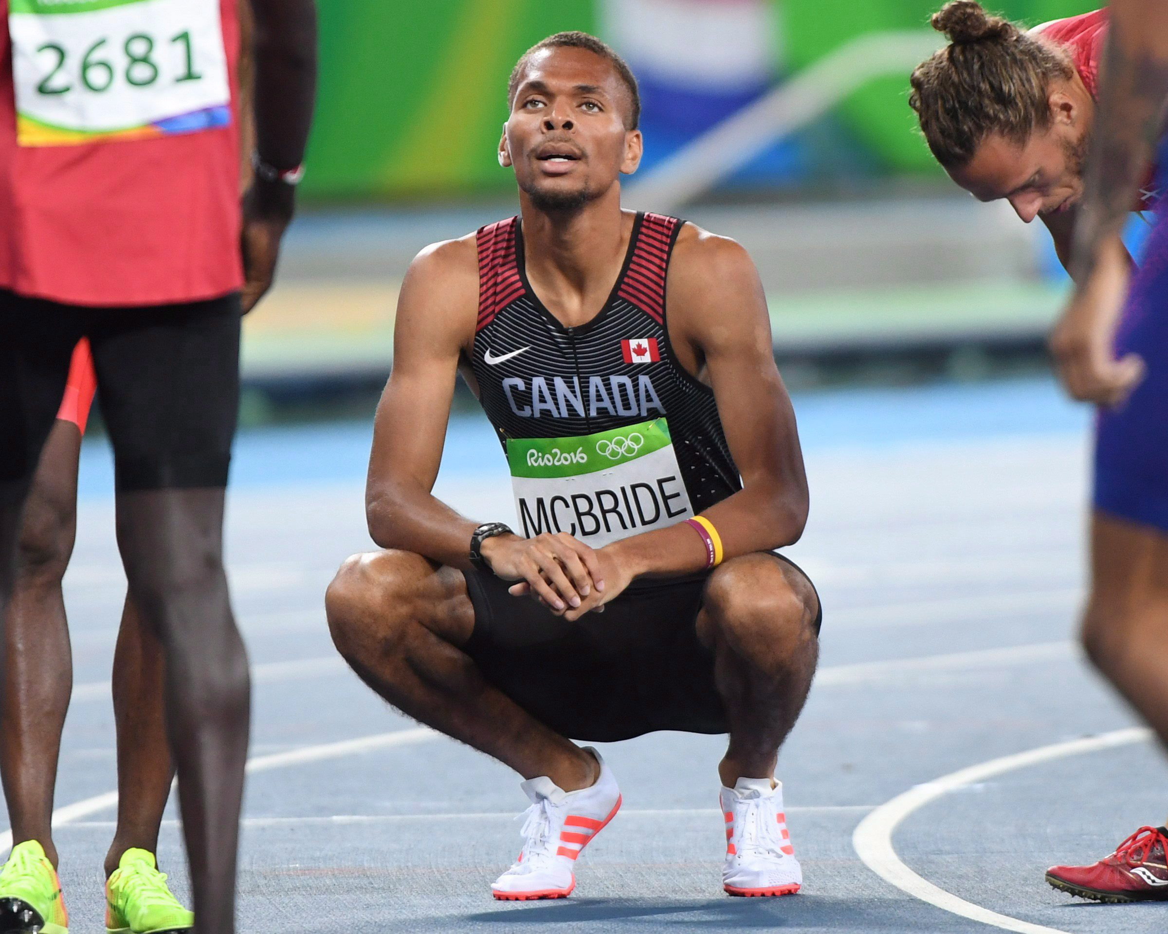 McBride squatting amongst other runners looking up