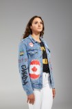 Kylie Masse lower side view of closing ceremony outfit with jean jack and white jeans.