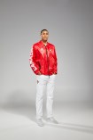 Lepage hands in pocket with red jacket and white pants looking at camera