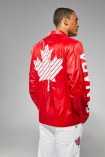 LePage back towards screen with jacket on. Showing maple leaf on back of jacket