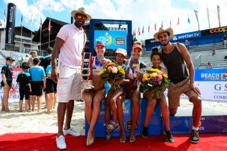 Brandie Wilkerson holds up flowers as she takes photo with her family after a match