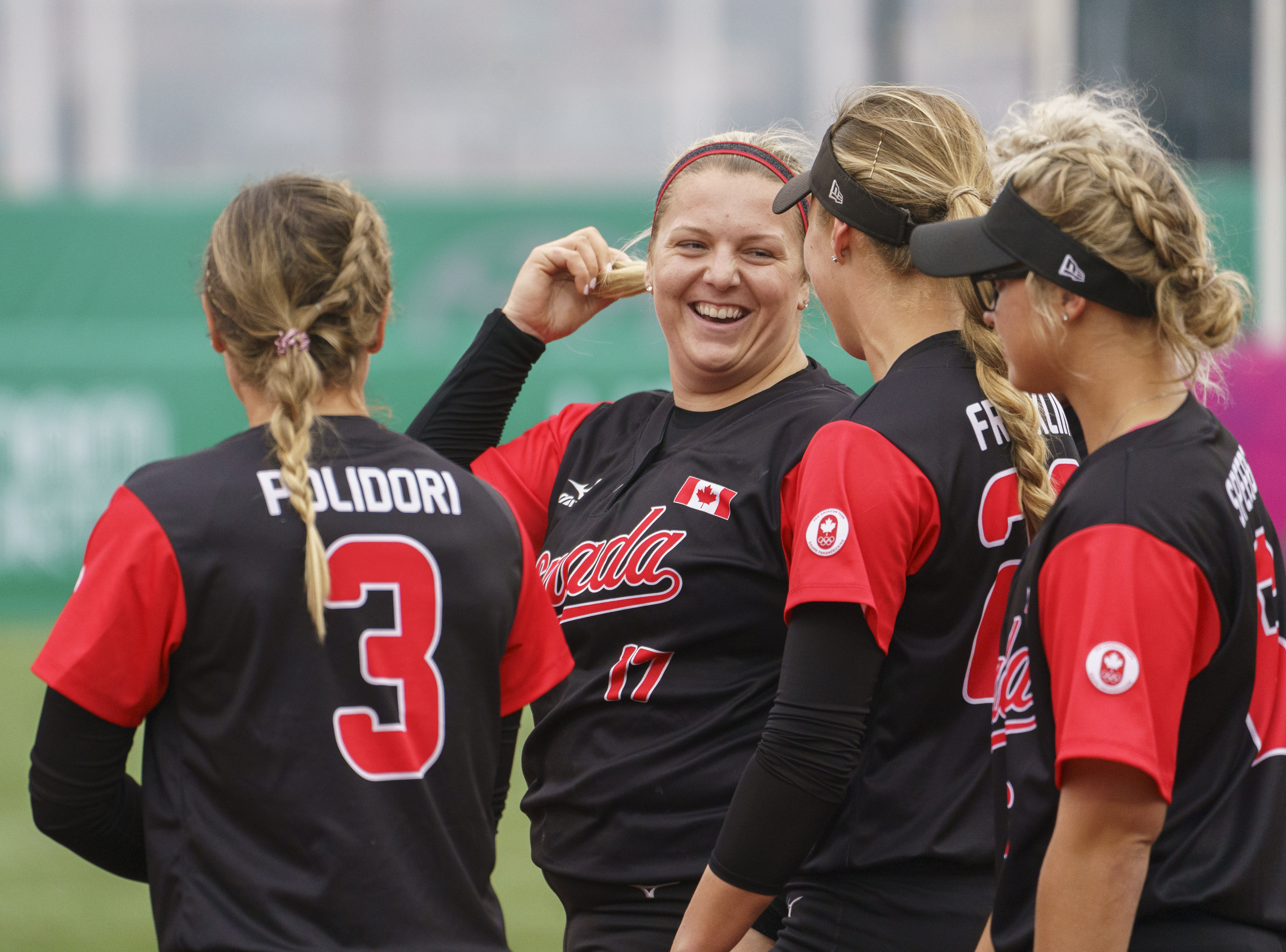 Members of women's softball team talking in a huddle