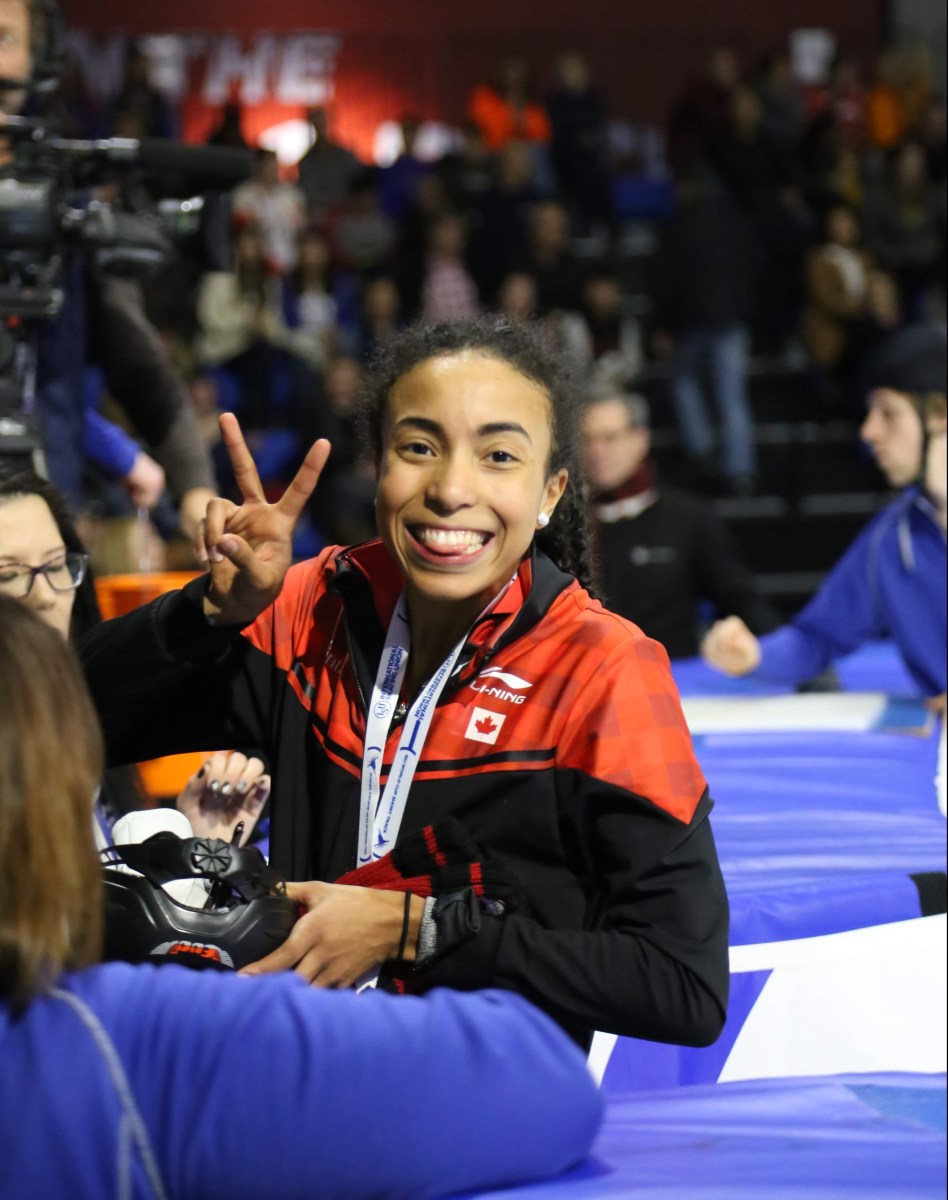 Alyson Charles shows a big smile with a trophy