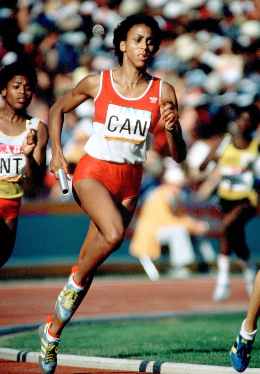 Charmaine Crooks running with a baton