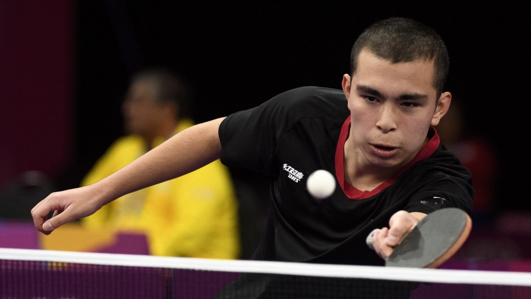 Male table tennis player prepares to return the ball