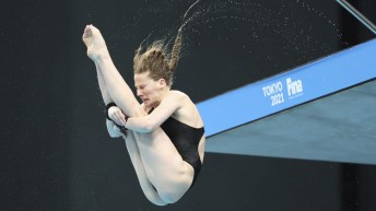 Female diver in pike position in the air